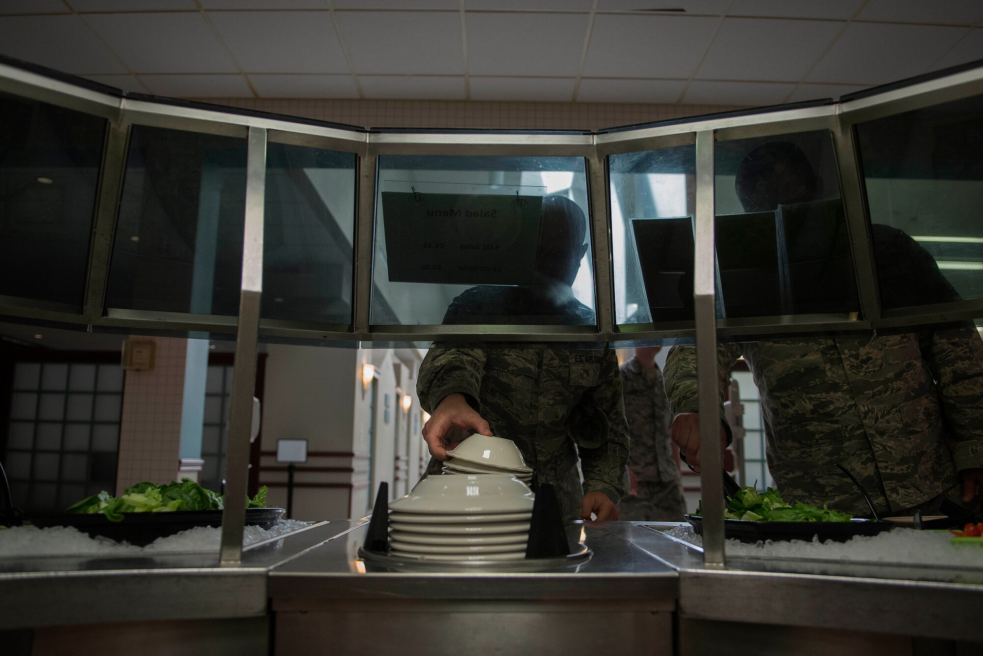Team Scott servicemembers begin to assemble their food during the lunch period at the Nightingale Inn Dining Facility at Scott Air Force Base, Illinois, June 29, 2016. The dining facility serves all enlisted personnel and other eligible individuals permanently or temporarily assigned to Scott.
