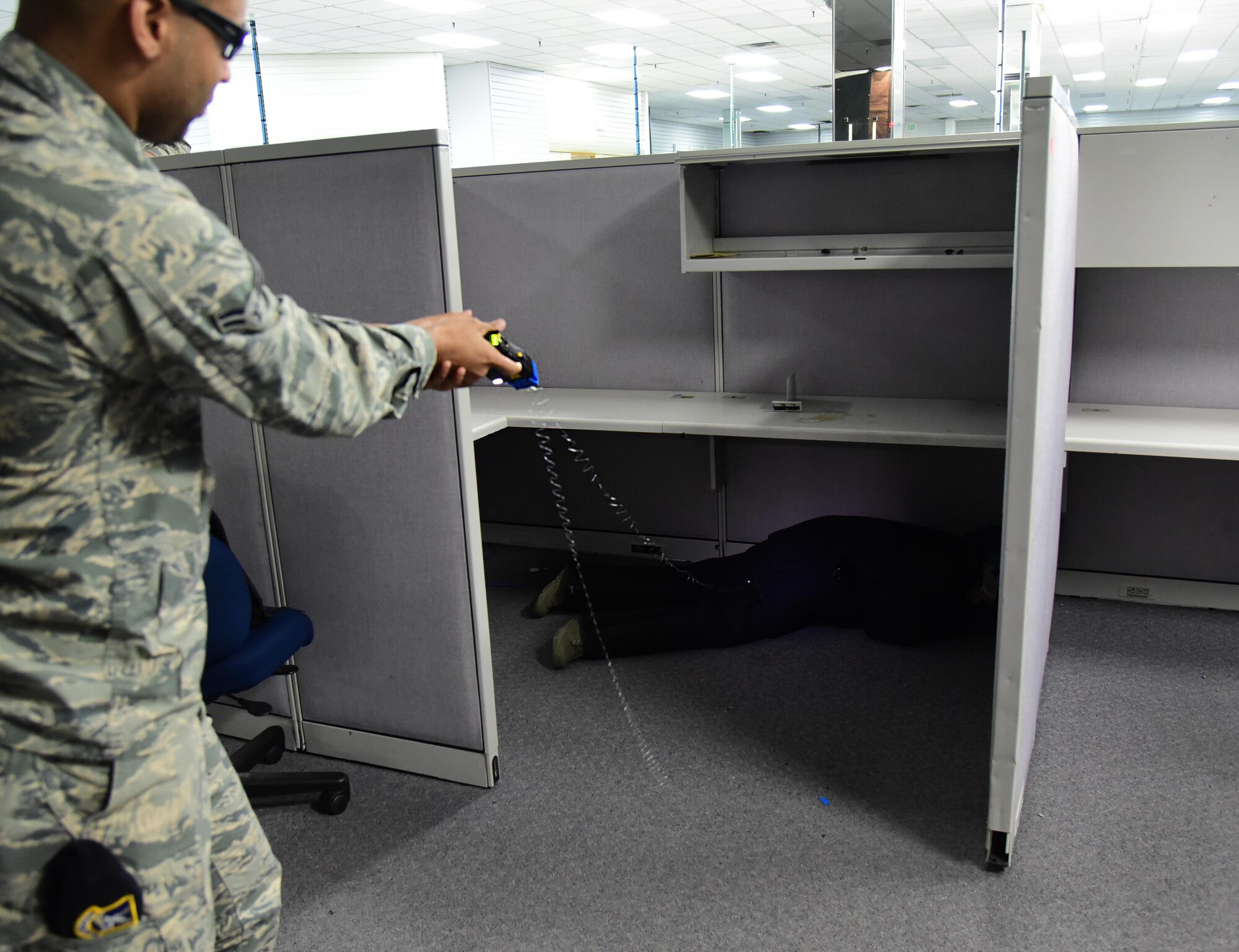 PETERSON AIR FORCE BASE, Colo. – Airman 1st Class Mekah Baker, 21st Security Forces Squadron patrolman, fires a Taser during the practical application portion of the Baton and Taser training course at Peterson Air Force Base, Colo., July 7, 2016. Trainees were taught how to adjust the use of a Taser to deal with resisting subjects in a various situations. (U.S. Air Force photo by Staff Sgt. Amber Grimm)