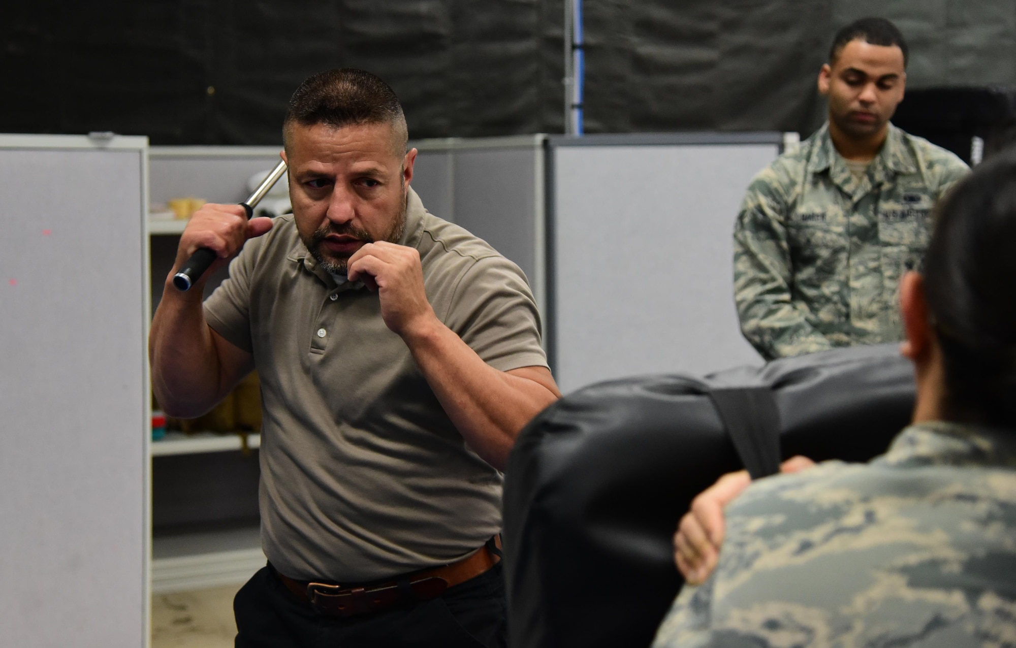 PETERSON AIR FORCE BASE, Colo. – Isaac Lopez, 21st Security Forces Squadron trainer, demonstrates proper baton technique during the practical application portion of the Baton and Taser training course at Peterson Air Force Base, Colo., July 7, 2016. Lopez went over basic strikes and angles in order to apply the proper amount of force in a hostile situation without causing undo injury. (U.S. Air Force photo by Staff Sgt. Amber Grimm)