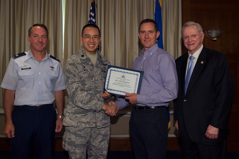 Chris Barker, center right, Michael Stein McLean Mortgage consultant, receives a certificate from Lt. Col. Jiffy Seto, center left, 579th Medical Operations Support Squadron commander; Col. Bradley Hoagland, far left, 11th Wing and Joint Base Andrews commander; and Jim Estepp, far right, Andrews Business & Community Alliance president and chief executive officer and Senior Andrews Ambassador, at The Club on Joint Base Andrews, Md., July 7, 2016. The JBA Honorary Commander Program allows communication and partnerships between key leaders of the base and surrounding community. (U.S. Air Force photo by Airman 1st Class Philip Bryant)