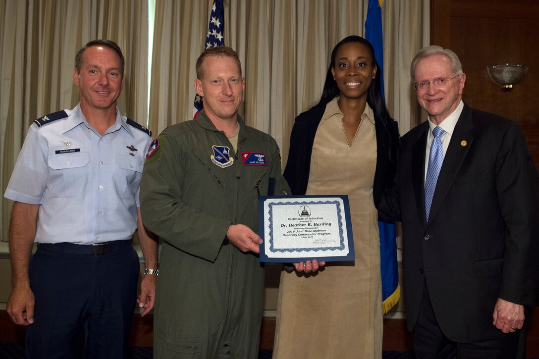 Heather Harding, center right, AESI chairwoman, chief executive officer and president, receives a certificate from Lt. Col. Marc Milligan, center left, 811th Operations Support Squadron commander; Col. Bradley Hoagland, far left, 11th Wing and Joint Base Andrews commander; and Jim Estepp, far right, Andrews Business & Community Alliance president and chief executive officer and Senior Andrews Ambassador, at The Club on Joint Base Andrews, Md., July 7, 2016. The JBA Honorary Commander Program allows communication and partnerships between key leaders of the base and surrounding community. (U.S. Air Force photo by Airman 1st Class Philip Bryant)