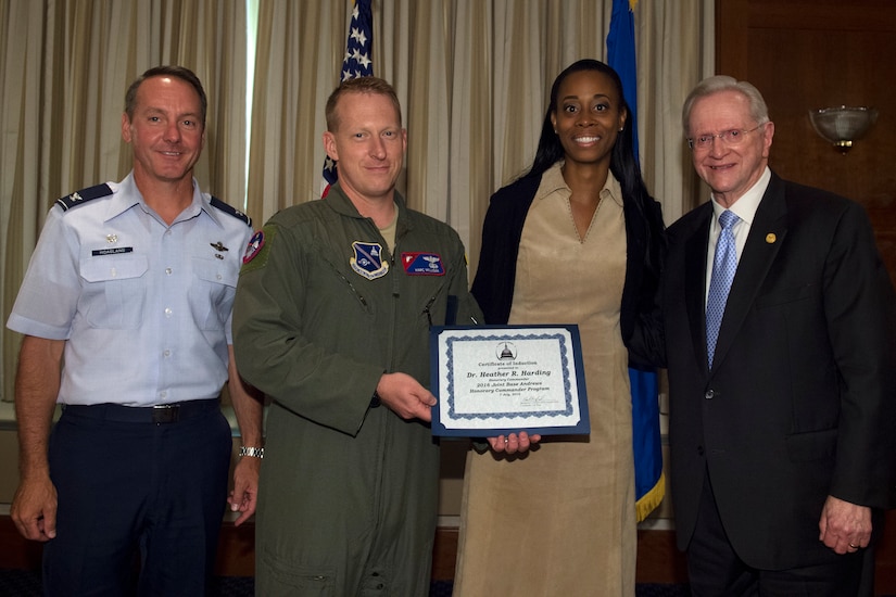 Heather Harding, center right, AESI chairwoman, chief executive officer and president, receives a certificate from Lt. Col. Marc Milligan, center left, 811th Operations Support Squadron commander; Col. Bradley Hoagland, far left, 11th Wing and Joint Base Andrews commander; and Jim Estepp, far right, Andrews Business & Community Alliance president and chief executive officer and Senior Andrews Ambassador, at The Club on Joint Base Andrews, Md., July 7, 2016. The JBA Honorary Commander Program allows communication and partnerships between key leaders of the base and surrounding community. (U.S. Air Force photo by Airman 1st Class Philip Bryant)