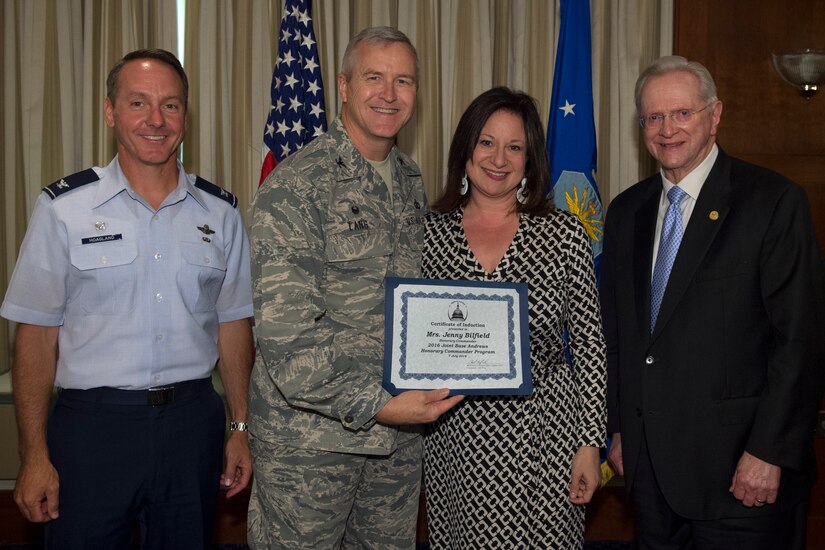 Jenny Bilfield, center right, Washington Performing Arts president and chief executive officer regional, receives a certificate from Col. Larry Lang, center left, U.S. Air Force Band commander; Col. Bradley Hoagland, far left, 11th Wing and Joint Base Andrews commander; and Jim Estepp, far right, Andrews Business & Community Alliance president and chief executive officer and Senior Andrews Ambassador, at The Club on Joint Base Andrews, Md., July 7, 2016. The JBA Honorary Commander Program allows communication and partnerships between key leaders of the base and surrounding community. (U.S. Air Force photo by Airman 1st Class Philip Bryant)