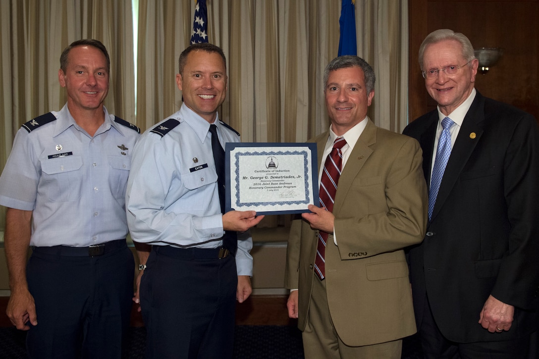 George Demetriades, Jr., center right, Chick-fil-a franchise owner and operator, receives a certificate from Col. Christopher Thompson, center left, 89th Airlift Wing vice commander; Col. Bradley Hoagland, far left, 11th Wing and Joint Base Andrews commander; and Jim Estepp, far right, Andrews Business & Community Alliance president and chief executive officer and Senior Andrews Ambassador, at The Club on Joint Base Andrews, Md., July 7, 2016. The JBA Honorary Commander Program allows communication and partnerships between key leaders of the base and surrounding community. (U.S. Air Force photo by Airman 1st Class Philip Bryant)