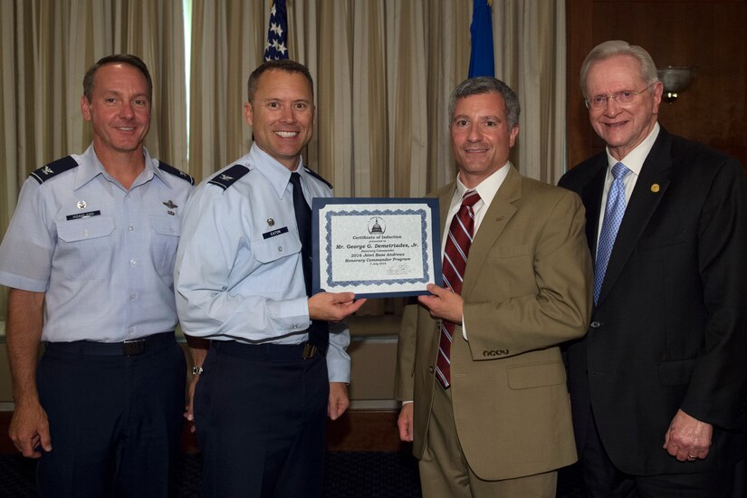 George Demetriades, Jr., center right, Chick-fil-a franchise owner and operator, receives a certificate from Col. Christopher Thompson, center left, 89th Airlift Wing vice commander; Col. Bradley Hoagland, far left, 11th Wing and Joint Base Andrews commander; and Jim Estepp, far right, Andrews Business & Community Alliance president and chief executive officer and Senior Andrews Ambassador, at The Club on Joint Base Andrews, Md., July 7, 2016. The JBA Honorary Commander Program allows communication and partnerships between key leaders of the base and surrounding community. (U.S. Air Force photo by Airman 1st Class Philip Bryant)