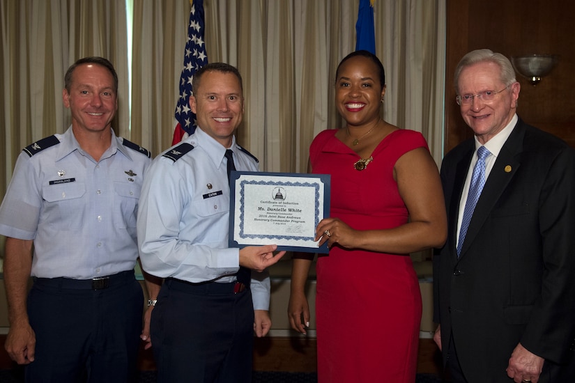 Danielle White, center right, MGM Casino regional vice president community engagements, receives a certificate from Col. Christopher Thompson, center left, 89th Airlift Wing vice commander; Col. Bradley Hoagland, far left, 11th Wing and Joint Base Andrews commander; and Jim Estepp, far right, Andrews Business & Community Alliance president and chief executive officer and Senior Andrews Ambassador, at The Club on Joint Base Andrews, Md., July 7, 2016. The JBA Honorary Commander Program allows communication and partnerships between key leaders of the base and surrounding community. (U.S. Air Force photo by Airman 1st Class Philip Bryant)