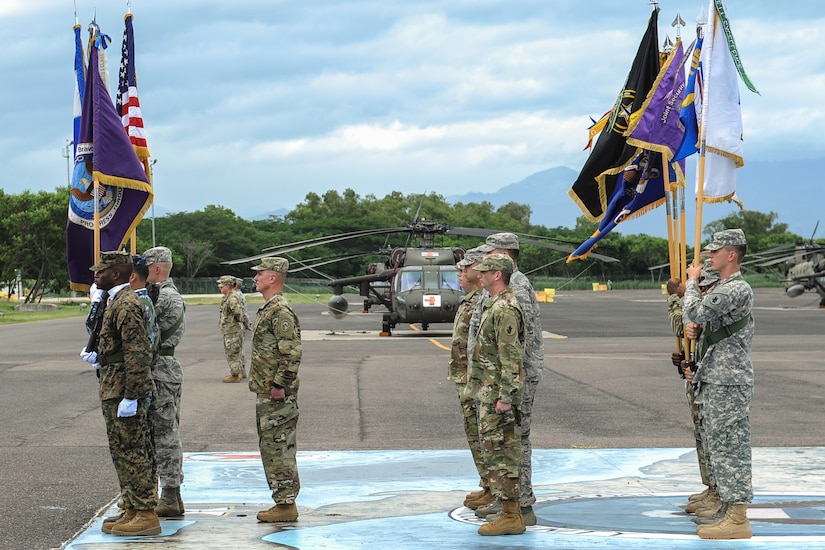 The Joint Task Force-Bravo color guard stands in front of the commanders and guidon-bearers of JTF-Bravo’s five major supporting commands during the JTF-Bravo change of command ceremony at Soto Cano Air Base, Honduras, July 7, 2016. JTF-Bravo operates a forward, all-weather C-5-capable air base, organizes multilateral exercises, supports counter transnational organized crime activity, humanitarian assistance/disaster relief, and building partner capacities. (U.S. Air Force photo by Staff Sgt. Siuta B. Ika)