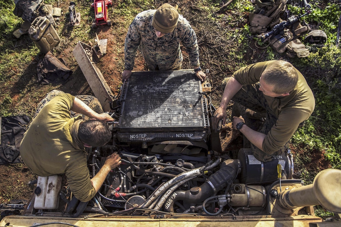 Marineswork on a Humvee engine during Exercise Hamel at the Cultana Training Area in Australia, July 8, 2016. The Marines are assigned to Headquarters and Service Company, 1st Battalion, 1st Marine Regiment, Marine Rotational Force Darwin. Marine Corps photo by Cpl. Mandaline Hatch