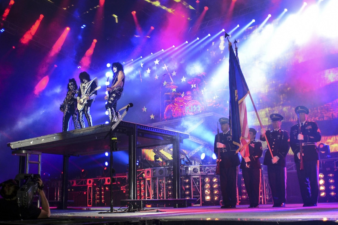 Members of the Oregon Army National Guard display the American flag on stage while the band Kiss performs the national anthem during the “Freedom to Rock” concert in Eugene, Ore., July 9, 2016. The soldiers provided a color guard for the band’s patriotic tribute to U.S. military and veterans at the concert. Oregon National Guard photo by Maj. W. Chris Clyne