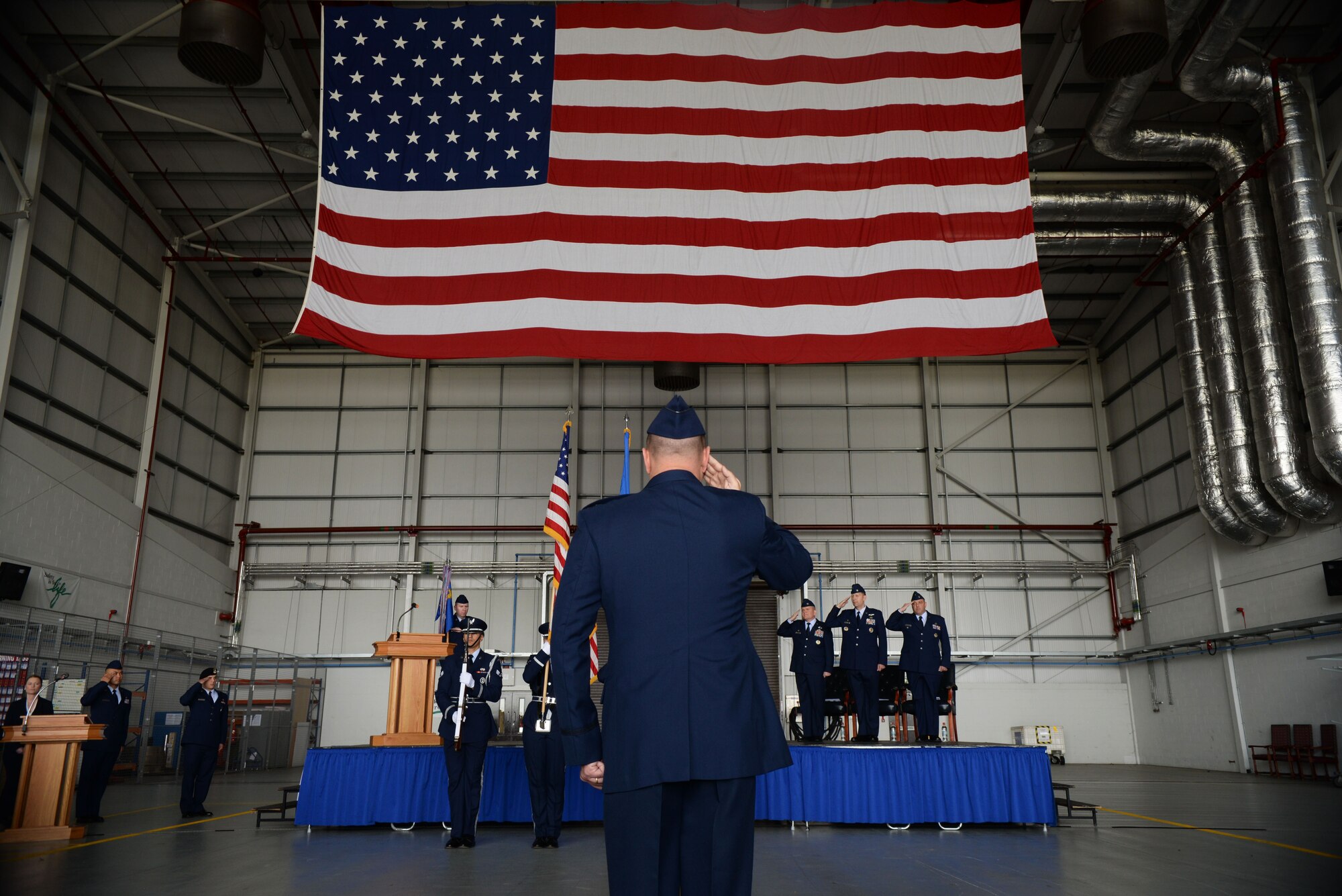 U.S. Air Force Airmen from the 100th Mission Support Group salute the American Flag June 29, 2016, during a change of command ceremony on RAF Mildenhall, England. During the ceremony, U.S. Air Force Col. Robert Hoskins assumed command of the 100th MSG. (U.S. Air Force photo by Airman 1st Class Tenley Long/Released)