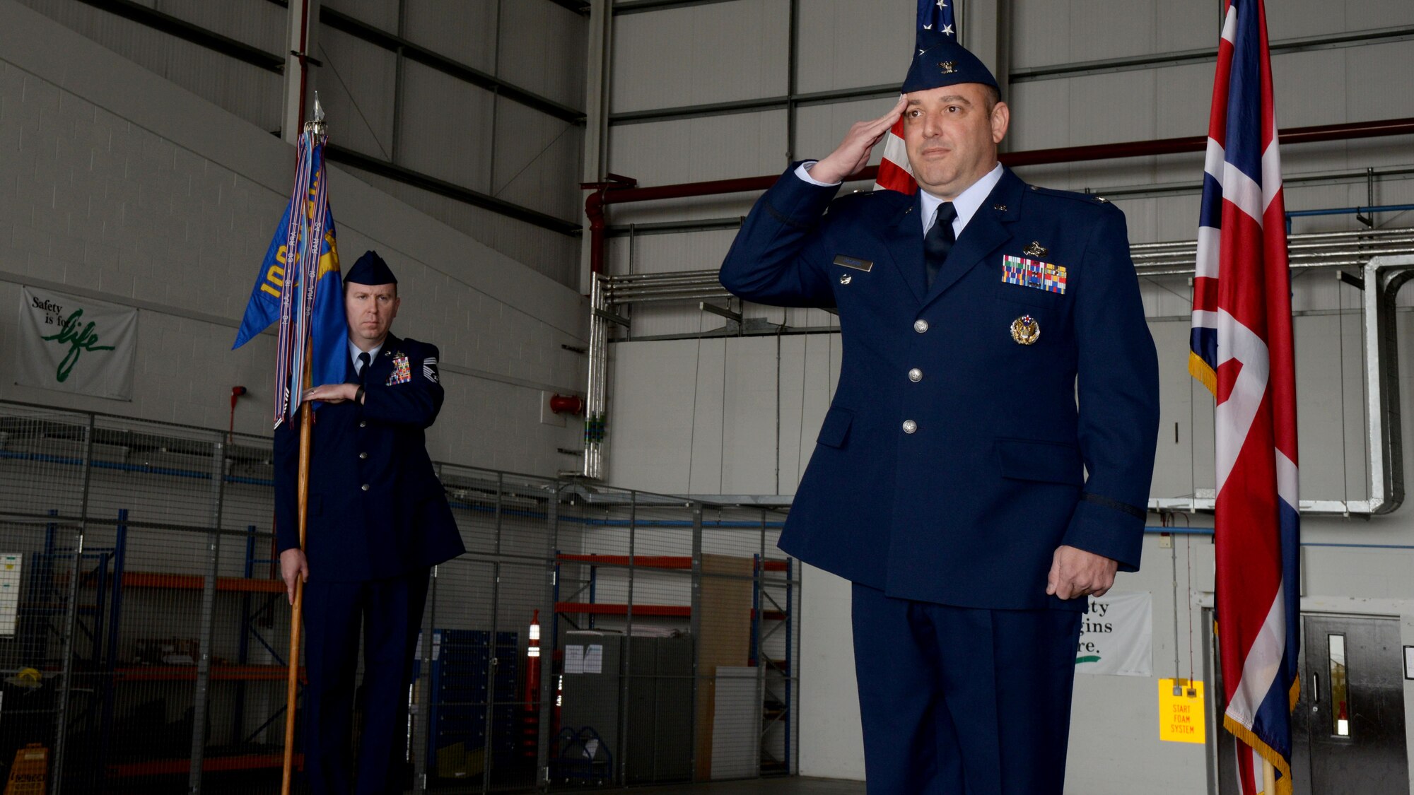 U.S. Air Force Col. Robert Hoskins, right, new 100th Mission Support Group commander, renders his first salute to Airmen from the 100th MSG June 29, 2016, during a change of command ceremony on RAF Mildenhall, England. The ceremony is a time-honored tradition in which one officer relinquishes command and passes it to another. (U.S. Air Force photo by Airman 1st Class Tenley Long/Released)