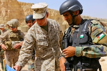 U.S. Marine CWO-2 Ronald P. Forristal, Battalion Gunner for 2nd Battalion, 7th Marine Regiment, Special Purpose Marine Air Ground Task Force Crisis Response Central Command 16.2, discusses shot groups with a member of the Jordanian Armed Forces from his battle sight zero drills during Exercise Eager Lion 16 at King Abdullah II Special Operations Training Center, Kingdom of Jordan on May 17, 2016. Eager Lion 16 is a US military bi-lateral exercise with the Hashemite Kingdom of Jordan designed to strengthen relationships and interoperability between partner nations. (U.S. Marine Corps photo by Cpl. Lauren Falk 5th MEB COMCAM/Released)