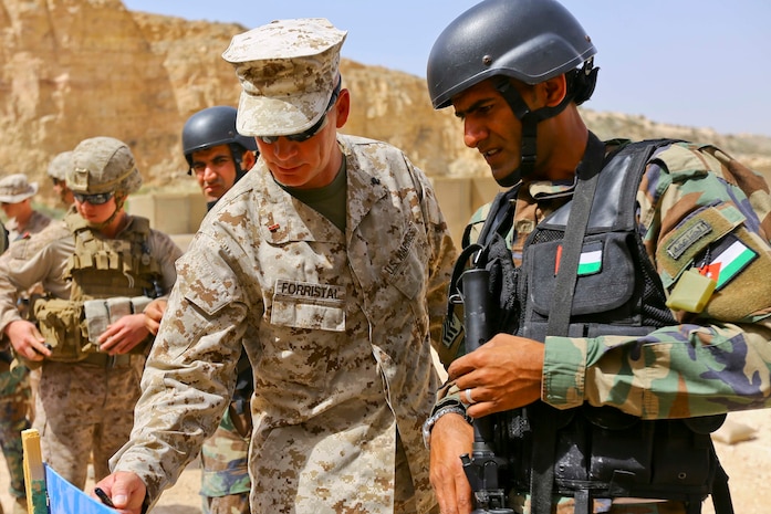 U.S. Marine CWO-2 Ronald P. Forristal, Battalion Gunner for 2nd Battalion, 7th Marine Regiment, Special Purpose Marine Air Ground Task Force Crisis Response Central Command 16.2, discusses shot groups with a member of the Jordanian Armed Forces from his battle sight zero drills during Exercise Eager Lion 16 at King Abdullah II Special Operations Training Center, Kingdom of Jordan on May 17, 2016. Eager Lion 16 is a US military bi-lateral exercise with the Hashemite Kingdom of Jordan designed to strengthen relationships and interoperability between partner nations. (U.S. Marine Corps photo by Cpl. Lauren Falk 5th MEB COMCAM/Released)