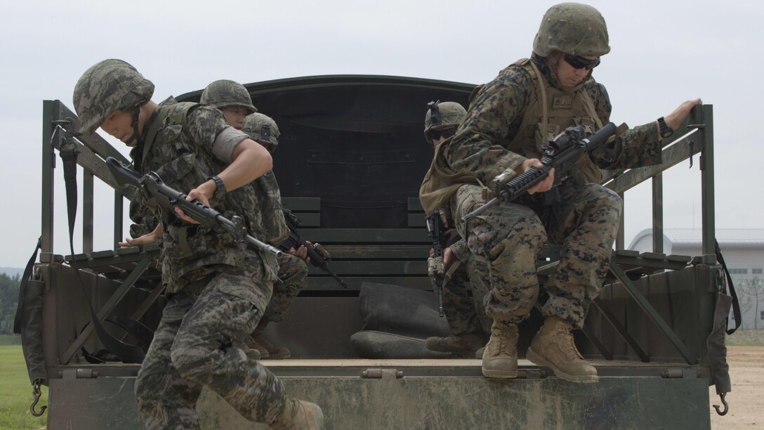 A Republic of Korea Marine and a U.S. Marine jump from the back of a truck during convoy escort training July 11, 2016 during Korean Marine Exchange Program 16-11. KMEP offers realistic training leveraging the most advanced tactics and technology to ensure a trained and ready ROK-U.S. combined force. The ROK Marines are with 73rd Battalion, 7th Regiment, 1st Marine Division. The U.S. Marines participating in this training event are with 2nd Battalion, 2nd Marine Regiment, currently assigned to 4th Marine Regiment, 3rd Marine Division, III Marine Expeditionary Force through the unit deployment program.