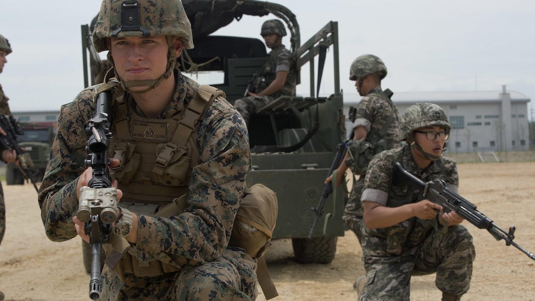 Cpl. Beau M. Higgins posts security beside a Republic of Korea Marine during convoy escort training July 11, 2016 during Korean Marine Exchange Program 16-11. KMEP offers realistic training leveraging the most advanced tactics and technology to ensure a trained and ready ROK-U.S. combined force. The ROK Marines are with 73rd Battalion, 7th Regiment, 1st Marine Division. Higgins, a Layton, Utah, native, is a cyber network specialist with 2nd Battalion, 2nd Marine Regiment, currently assigned to 4th Marine Regiment, 3rd Marine Division, III Marine Expeditionary Force through the unit deployment program.