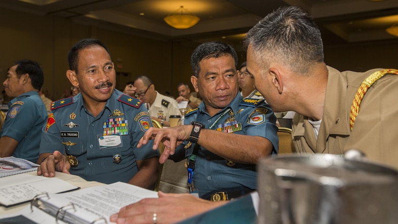 Indonesian Marine Corps Col. Hermanto, center, assistant for planning to Indonesian Marine Corps Commander, speaks to U.S. Marine Corps Lt. Col. Koichi Takagi, right, Marine attaché to Indonesia, during the USPACOM Amphibious Leaders Symposium in San Diego, California, July 11, 2016. PALS brings together senior leaders of allied and partner nations from the Indo-Asia-Pacific region to discuss key aspects of maritime/amphibious operations, capability development, crisis response, and interoperability. Twenty-two allied and partnered nations, including the U.S. are participating.