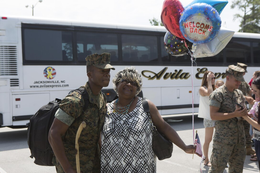 Staff Sgt. Ronald Conyers, an infantry unit leader with Black Sea Rotational Force, returns from a six-month deployment in Eastern Europe and embraces his family during a homecoming ceremony on Camp Lejeune, N.C., July 10, 2016. The Marines conducted various training missions that helped strengthen international relations with numerous NATO countries in preparation to support multinational contingency missions. (U.S. Marine Corps Photo by Cpl. Shannon Kroening/Released)