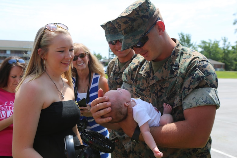 Sgt. William Carrier, a tactical switching operator with the Black Sea Rotational Force, returns from a six-month deployment in Eastern Europe and embraces the newborn baby of one of his fellow Marines during a homecoming ceremony on Camp Lejeune, N.C., July 10, 2016. The Marines operated out of Bulgaria and Romania alongside other NATO nations to improve upon their multinational relations and to improve their ability to fight as one strong cohesive force.  (U.S. Marine Corps Photo by Cpl. Shannon Kroening/Released)