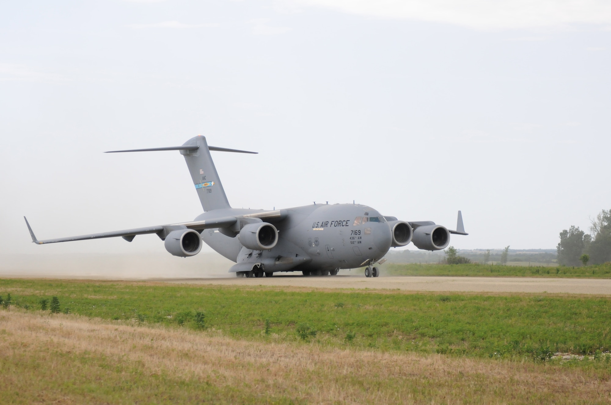 A Boeing C-17 Globemaster III operated by pilots of the 3rd Airlift Squadron, 436th Airlift Wing at Dover Air Force Base taxis along the landing strip at Savage Airfield June 25, 2016 at Fort Riley, Kansas. Air Force Personnel of the Global Reach Laydown team attached to a Contingency Response Group exited the aircraft to evaluate the area, establish communications with Dover and determined where to set up a bare base. (US Army photo/Season Osterfeld)