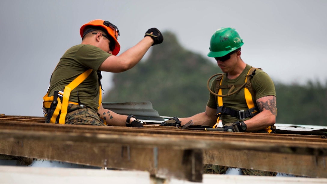 U.S. Marines Lance Cpl. Nathan D. Lyons and Cpl. Derek C. Brisendine, combat engineers with  Task Force Koa Moana 16.2, conduct vertical construction training at St. John’s College, Ovalau, Fiji, July 4, 2016.  Marines and Sailors with the task force will share engineering skills with Fijians to strengthen mil-to-mil relationships and interoperability.