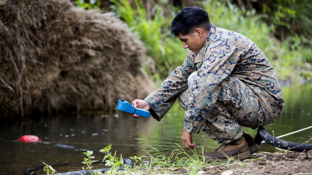 U.S. Marine Lance Cpl. Juan S. Peres, a water support technician with Task Force Koa Moana 16.2, measures the total dissolve solids in the creek water with a TDS meter at Ovalau, Fiji, July 3, 2016. Marines and sailors with the task force will share engineering skills with Fijians to strengthen mil-to-mil relationships and interoperability. 
