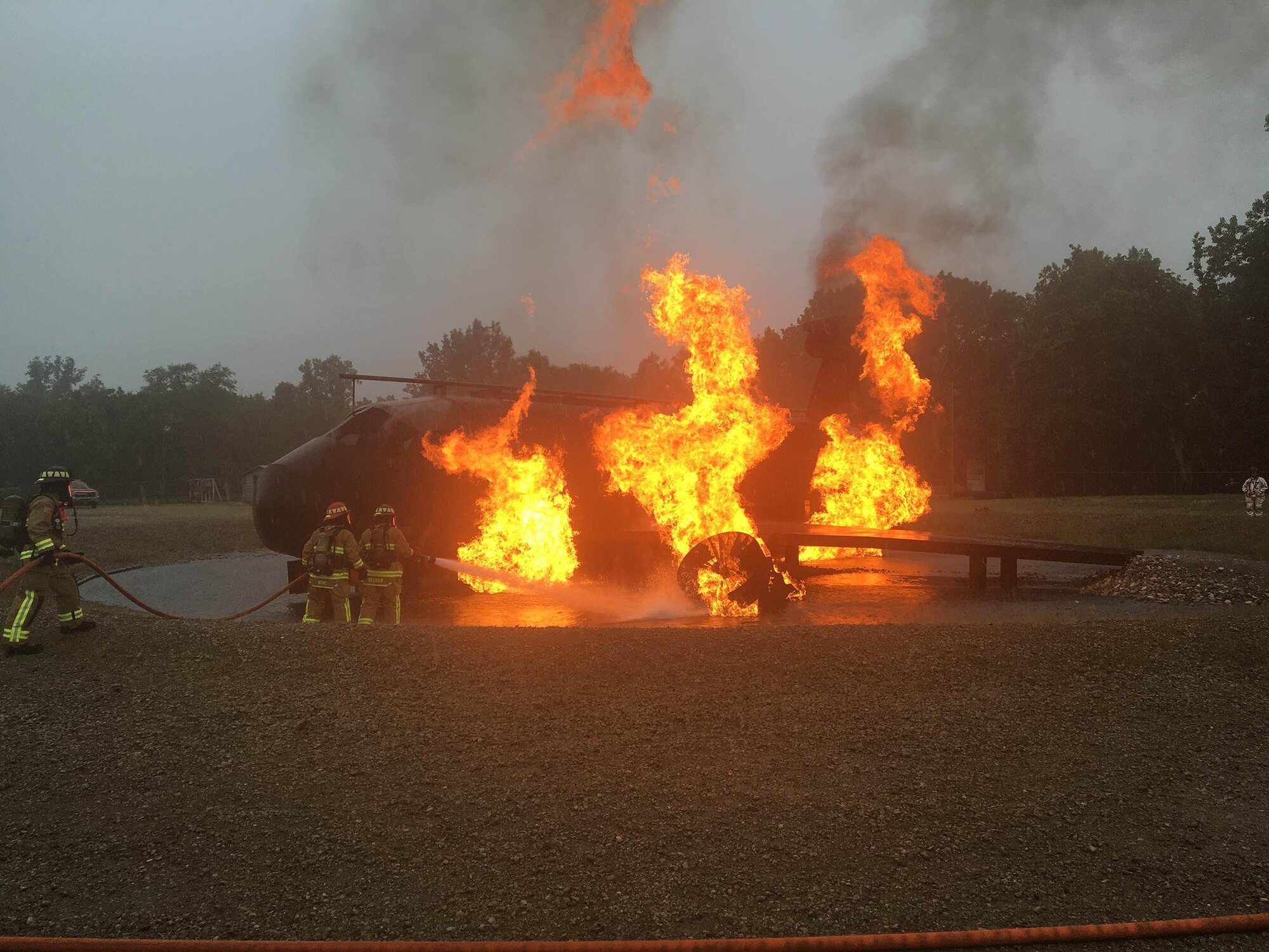 The 445th CES fire and emergency personnel practice fire pit and structural training, June 4, 2016, at the Wright-Patterson Air Force Base Warfighter Training Center. The entire CES completed bivouac (temporary camp without tents or cover) training June 3-4, 2016 as part of the wing’s unit effectiveness inspection. (U.S. Air Force photo/Senior Airmen Joel A. McCullough)