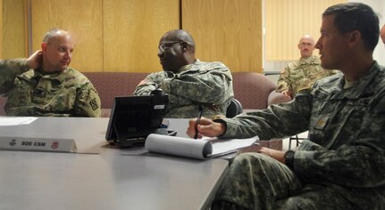 Lt. Col. Charles Bell, 1st. Sgt. Stephon McAfee and Maj. Carlos Acosta, 841st Engineer Battalion, U.S. Army Reserve, July 5th 2016, discuss the current operational posture during Resolute Castle at Novo Selo Training Area, Bulgaria. Resolute Castle is a U.S. led effort in Eastern Europe designed to improve military infrastructure and security in the region. (U.S. Army photo by Capt. Kimberlee Lewis, 841st Engineer Battalion, U.S. Army Reserve)