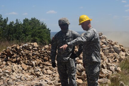 Capt. Aaron McDaniel, lead construction coordinator and Sgt. Gerald Bonilla, construction site leader, 841st Engineer Battalion, U.S. Army Reserve, July 6th, 2016, discuss construction during Resolute Castle at Novo Selo Training Area, Bulgaria. Resolute Castle is a U.S. led effort in Eastern Europe designed to improve military infrastructure and security in the region. (U.S. Army photo by Capt. Kimberlee Lewis, 841st Engineer Battalion, U.S. Army Reserve)