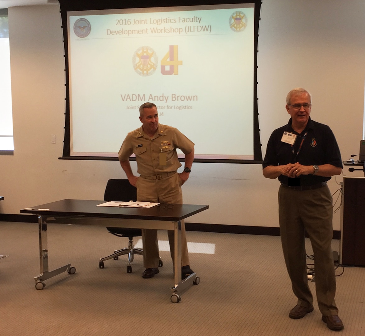 Navy Vice Admiral Andy Brown, Joint Staff Director for Logistics (left), is introduced by Lt Gen (Ret) Chris Kelly, Director of the Center for Joint & Strategic Logistics, prior to offering his insights and guidance to over 30 faculty and logistics staff members in attendance for the 2016 Joint Logistics Faculty Development Workshop.
