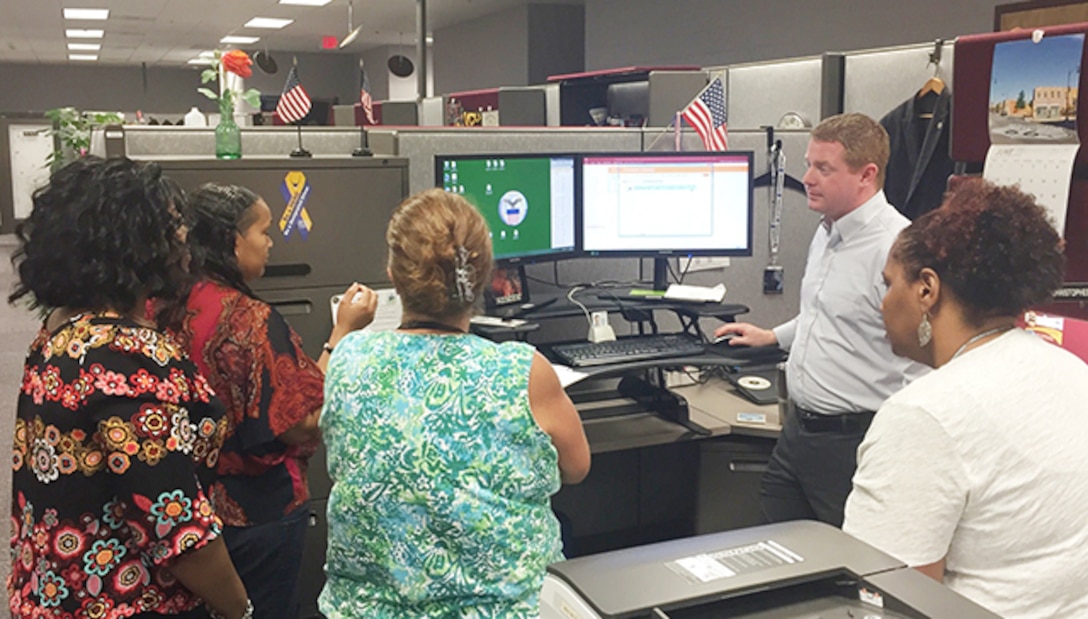 Members of Defense Logistics Agency Aviation’s Contracting Operations Support Team collaborate June 24, 2016 on how best to provide individualize customer support. 
