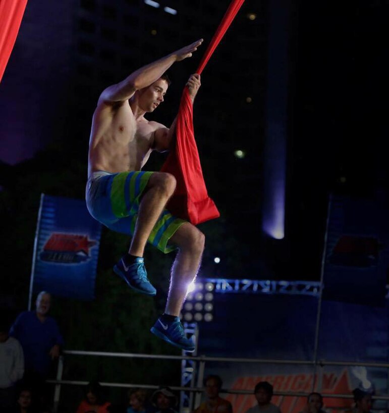 Michael Eckert swings onto flying curtains during the 2012 American Ninja Warrior southeast regional in Miami, Fla., April 17, 2012. Eckert placed fifth and later competed in the finals. After enlisting in the Marine Corps in March 2013, Eckert requalified in 2014 and competed a second time in the American Ninja Warrior finals in Las Vegas, Nev. Courtesy photo