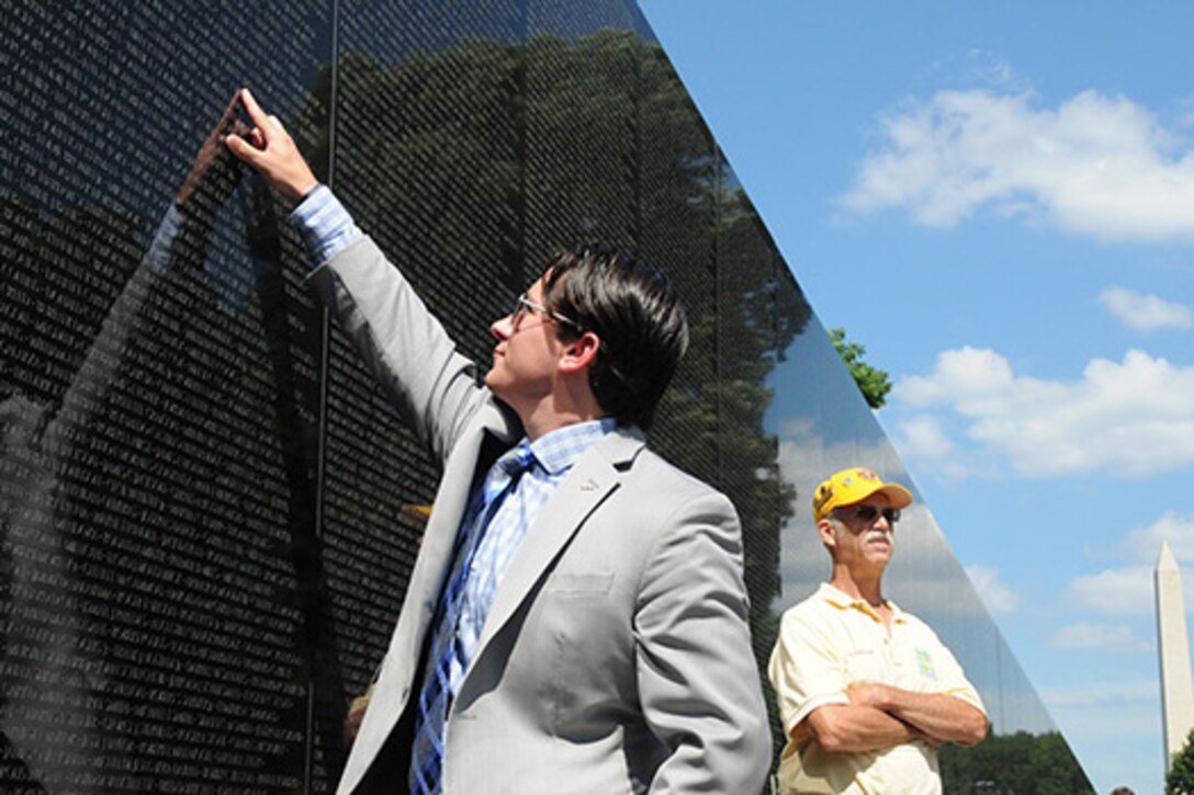 U.S. Army veteran Andrew Brennan, the founder of the Global War on Terrorism Memorial Foundation, points to a name he recognizes on the Vietnam Veterans Memorial in Washington, D.C. DoD photo by Katie Lange