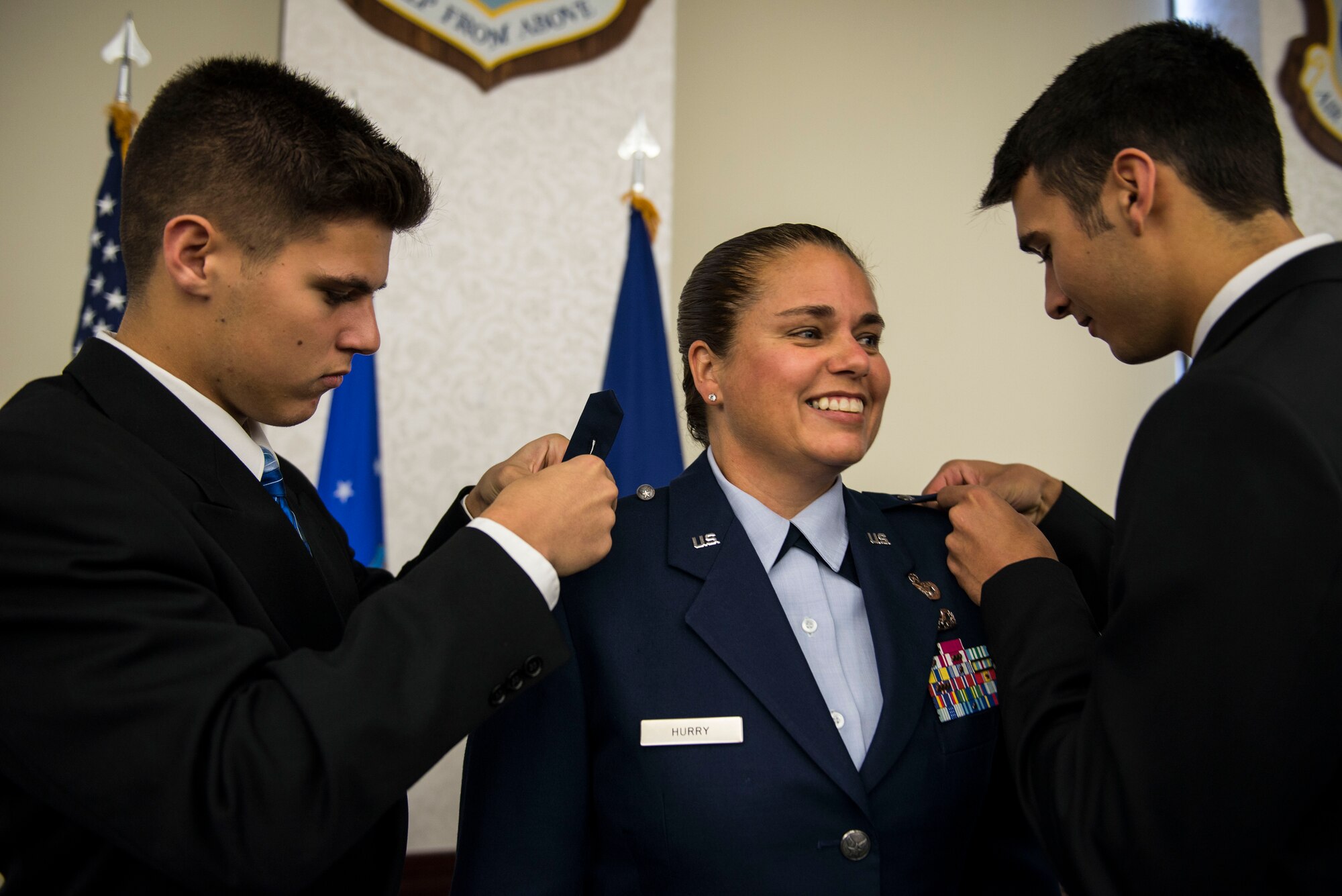 Col. Linda Hurry's sons, Aaron and Ryan, pin on their mother, commander of the 635th Supply Chain Operations Wing, during her promotion to Brig. Gen. on Scott Air Force Base, Ill., June 30, 2016.  Other family members in attendance were her daughter, Jordyn, her parents, Hank and Sonja, her brother, U.S. Army Lt. Col. Mare Washburn, and her aunts, Diane and Yvonne Washburn. (U.S. Air Force photo by Staff Sgt. Jodi Martinez)