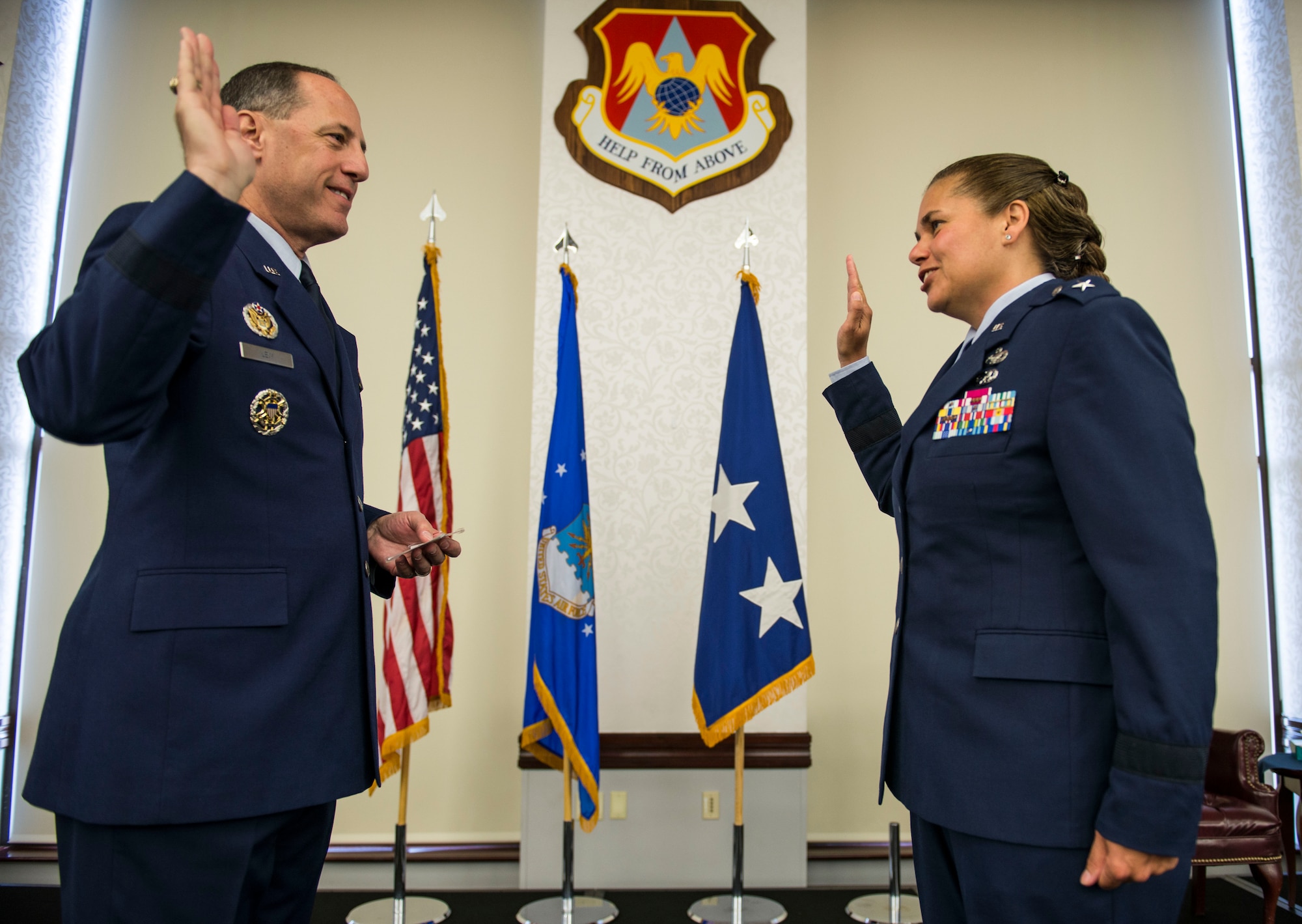 Lt. Gen. Lee K. Levy II, Air Force Sustainment Center Commander, swears in Brig. Gen. Linda Hurry, 635th Supply Chain Operations Wing Commander, during her promotion ceremony, June 30, 2016.  Hurry stressed that her success was a team effort and gave her thanks to her mentors and the family members that attended: her two sons, Ryan and Aaron, daughter, Jordyn, parents, Hank and Sonja, brother, U.S. Army Lt. Col. Mare Washburn, and aunts, Diane and Yvonne Washburn. (U.S. Air Force photo by Staff Sgt. Jodi Martinez)