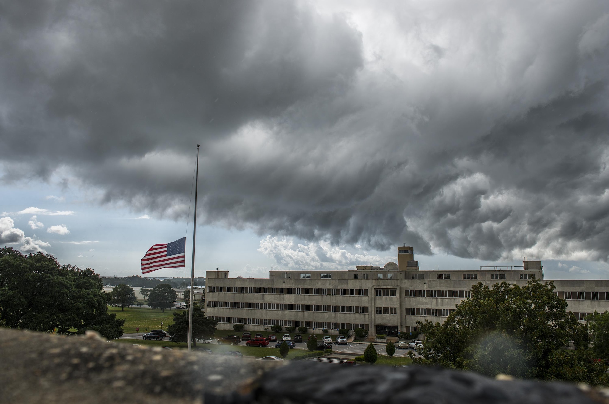 A dark storm cloud moves toward the 96th Test Wing headquarters building the morning of July 12 at Eglin Air Force Base, Fla.  The summer storm brought heavy rain, wind and lightning through the area, but was gone in less than an hour.  (U.S. Air Force photo/Samuel King Jr.)