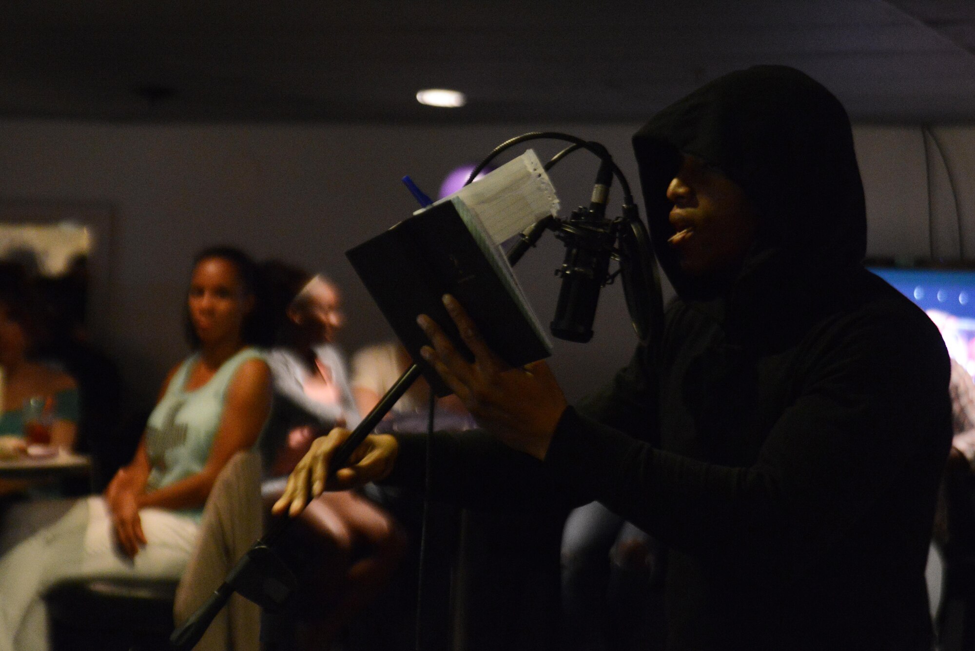 Airman 1st Class Aniah Everage, 673d Force Support Squadron food service apprentice, from Baltimore, Maryland, reads from his journal at the first Spoken Word Night at the Permafrost Pub at Joint Base Elmendorf-Richardson, Alaska, July 8, 2016. The Arctic Warrior Airmen’s Council hosted this event so poets can speak their mind and inspire others in a safe environment on base. (U.S. Air Force photo by Airman 1st Class Christopher R. Morales)