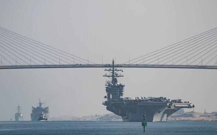 (July 8, 2016) The aircraft carrier USS Dwight D. Eisenhower (CVN 69), followed by the fast combat support ship USNS Arctic (T-AOE 8) and the guided-missile destroyer USS Nitze (DDG 94), passes under the Freedom Bridge while transiting the Suez Canal. The Eisenhower Carrier Strike Group is deployed in support of maritime security operations and theater security cooperation efforts in the U.S. 5th Fleet area of operations.  