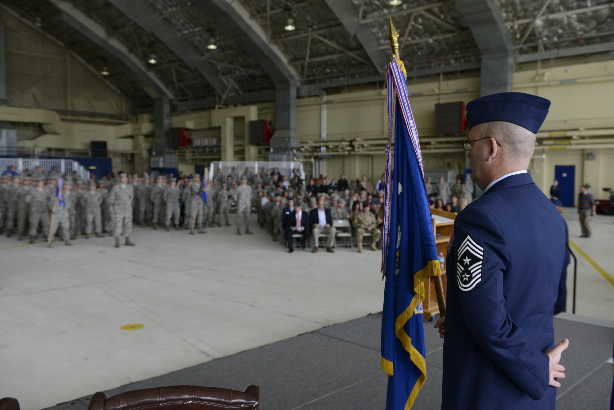 Chief Master Sgt. Gary Berry, 673d Air Base Wing command chief waits to hand the colors over at the Joint Base Elmendorf-Richardson, Alaska change of command ceremony at Hangar 1, July 11, 2016. U.S. Air Force Col. Brian Bruckbauer turned over command to Air Force Col. George Dietrich III as Air Force Lt. Gen. Russell Handy, the appointed commander of Pacific Air Forces; Air Component Commander for the U.S. Pacific Command, officiated before gathered family members, distinguished guests and military personnel. (U.S. Air Force photo by Senior Airman Kyle Johnson)