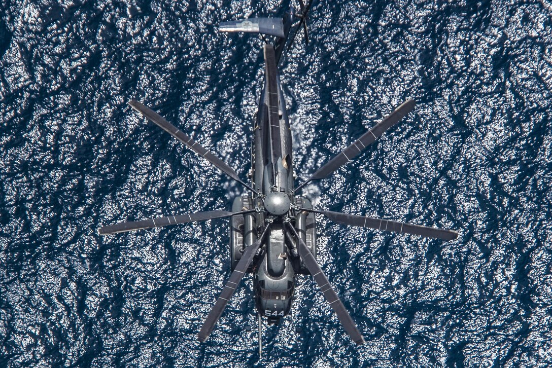 An MH-53E Sea Dragon flies above the Pacific Ocean, July 11, 2016, during  Rim of the Pacific 2016, the world's largest international maritime exercise. Twenty-six nations and 25,000 personnel are participating in event, which runs to Aug. 4 in Southern California and around the Hawaiian Islands. The helicopter is assigned to Mine Countermeasures Squadron 14. Navy photo by Petty Officer 2nd Class Stacy M. Atkins Ricks