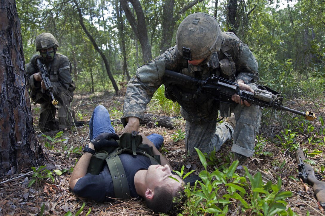 A soldier searches a role player acting as an enemy prisoner during training at Camp Rudder at Eglin Air Force Base, Fla., July 8, 2016. Army photo by Sgt. Austin Berner