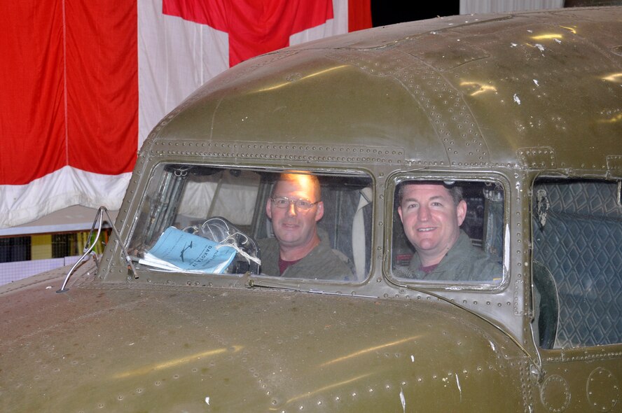 Lt. Cols. Jim Aaron, director of operations, left, and Rick Berls, commander, right, both of the 76th Air Refueling Squadron, sit in the cockpit of a C-47 on display at the Royal Air Force Welford Historic Museum.  The 76th ARS traces its lineage back to the 435th Troop Carrier Group which flew the vintage aircraft during World War II. (U.S. Air Force photo/Lt. Col. Kimberly Lalley)