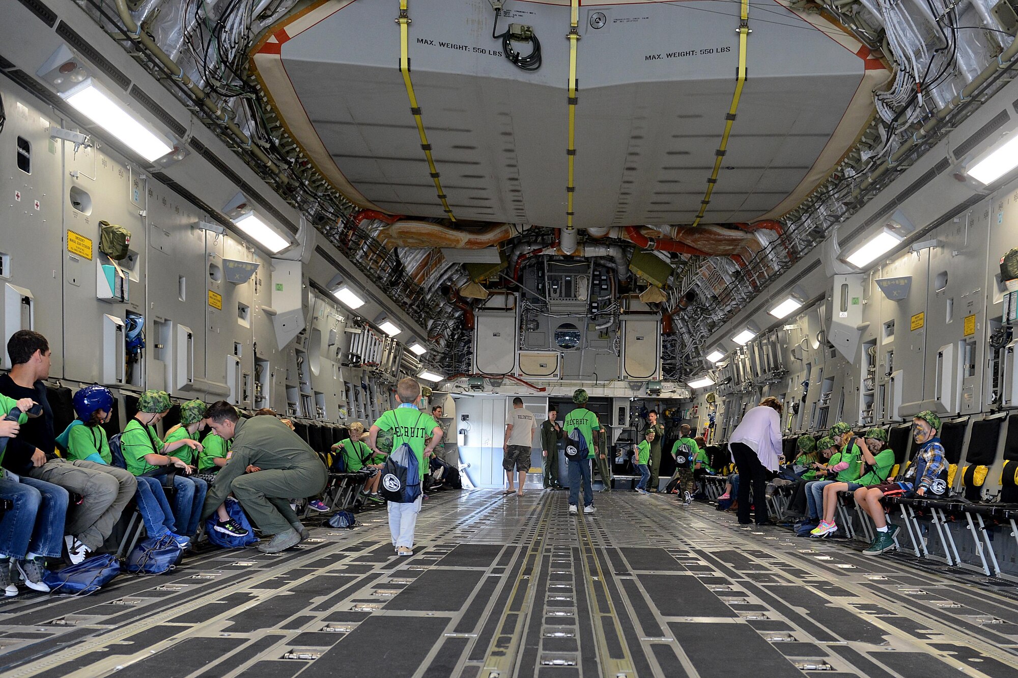 Children tour a McChord C-17 Globemaster III during a Kids Understanding Deployment Operations event July 9, 2016, on McChord Field, Wash. The children had the opportunity to see aircraft that their parents deploy on, and were briefed by loadmasters on emergency procedures and how long the flight was to Camp Kudo. (U.S. Air Force photo/Senior Airman Divine Cox)