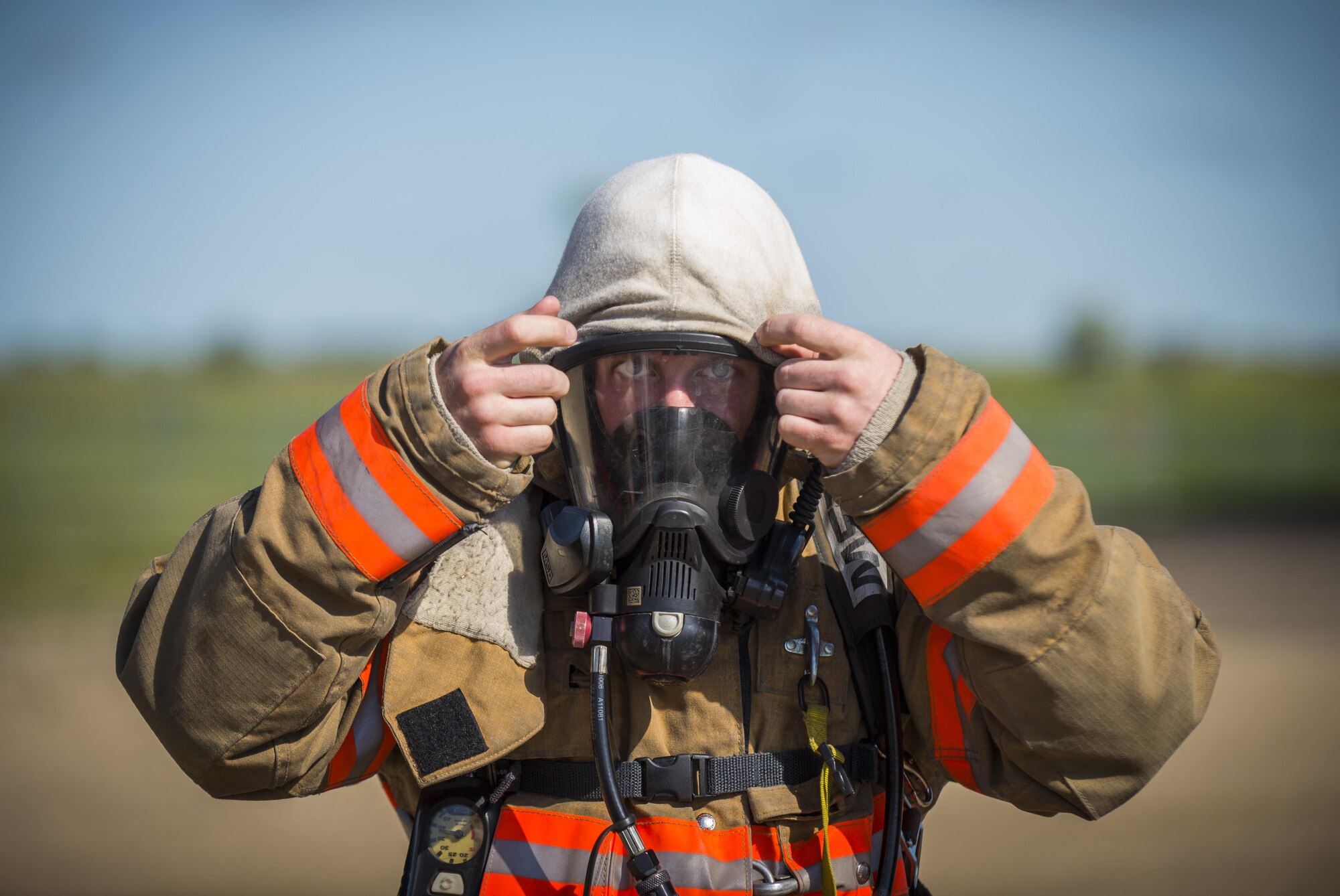 A 5th Civil Engineer Squadron firefighter puts on his firefighting gear at Minot Air Force Base, N.D., July 8, 2016. The fire protection flight’s goal is to protect MAFB’s people, property and the environment from fires and disasters by providing fire prevention, firefighting, rescue and hazardous material response. (U.S. Air Force photo/Airman 1st Class Christian Sullivan)