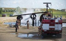 5th Civil Engineer Squadron firefighters hose down a fire during a training exercise at Minot Air Force Base, N.D., July 8, 2016. The fire protection flight’s goal is to protect MAFB’s people, property and the environment from fires and disasters by providing fire prevention, firefighting, rescue and hazardous material response. (U.S. Air Force photo/Airman 1st Class Christian Sullivan)