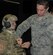 First Lt. Anthony Eastin clips the tablet into the Bat Rack, a mounting device created by the Battlefield Air Targeting Man-Aided Knowledge team in the 711th Human Performance Wing's Airman Systems Directorate. This mounting device enables operators to carry and easily access their tablets. (U.S. Air Force photo/Gina Marie Giardina) 