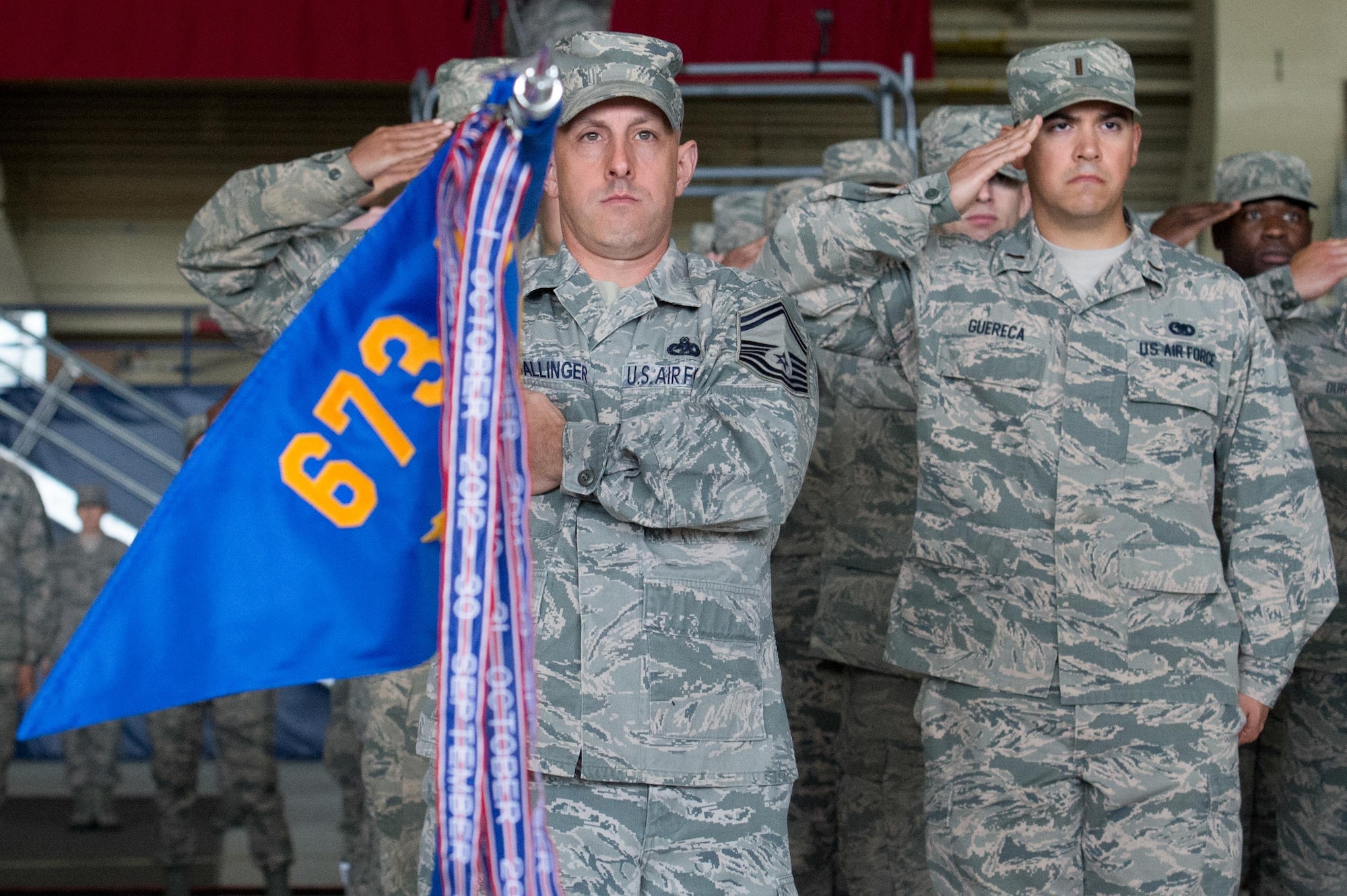 The formation salutes during the 673d Air Base Wing and Joint Base Elmendorf-Richardson, Alaska, change of command ceremony at Hangar 1 on JBER, Monday, July 11, 2016. U.S. Air Force Col. Brian Bruckbauer turned over command to Air Force Col. George Dietrich III as Air Force Lt. Gen. Russell Handy, the appointed commander of Pacific Air Forces, officiated before gathered family members, distinguished guests and military personnel. (U.S. Air Force photo/Justin Connaher)
