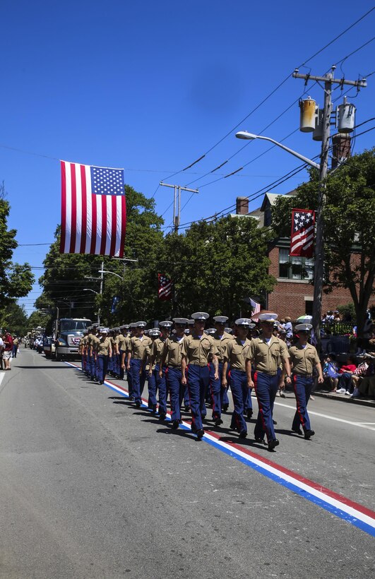Marines with 8th Communication Battalion march during the Bristol Fourth of July Parade in Bristol, Rhode Island, July 4, 2016. Marines marched directly behind the sailors of the USS Arlington and Navy officer candidates from Naval Officer Training Command Newport, RI. (U.S. Marine Corps photo by Cpl. Paul S. Martinez/Released)
