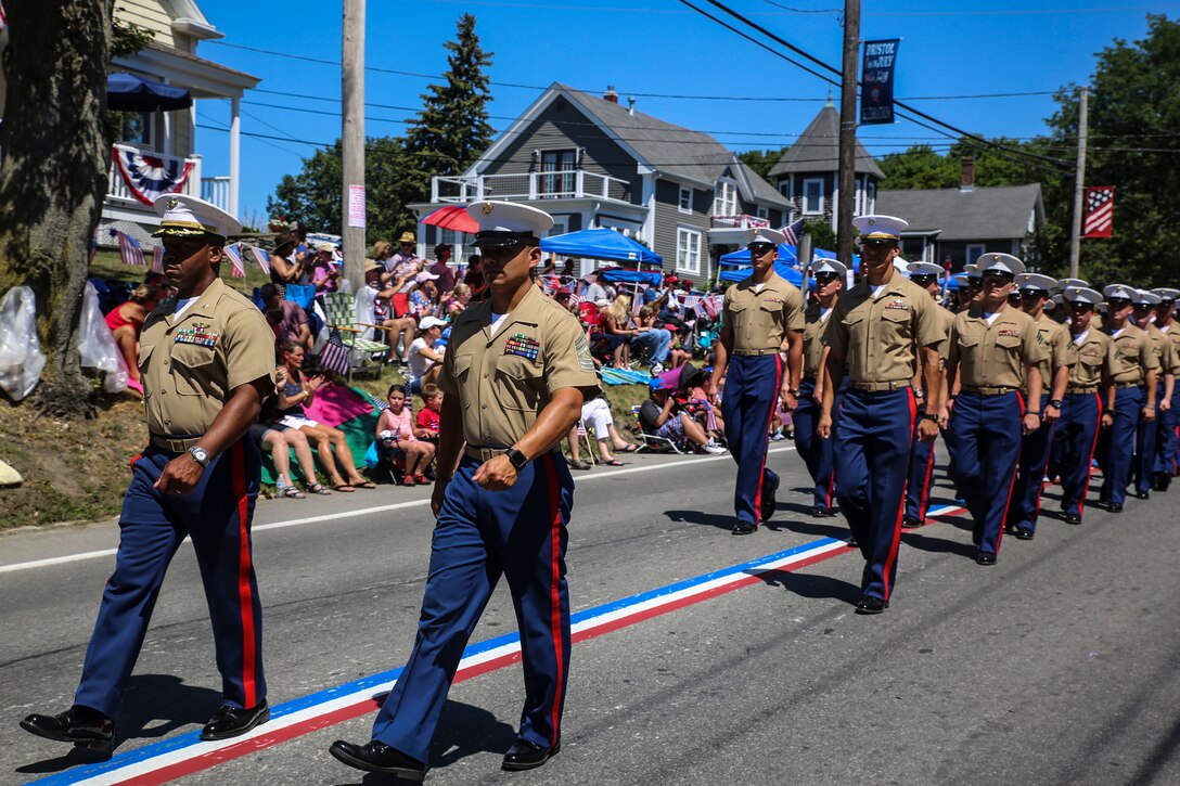 Maj. Marc Walker, operations officer, 8th Communication Battalion, and 1st Sgt. Hector Hernandez, first sergeant, Headquarters Company, 8th Comm. Bn., lead Marines with 8th Communication Battalion during the Bristol Fourth of July Parade in Bristol, Rhode Island, July 4, 2016. Marines marched directly behind the sailors of the USS Arlington and Navy officer candidates from Naval Officer Training Command Newport, RI. (U.S. Marine Corps photo by Cpl. Paul S. Martinez/Released)