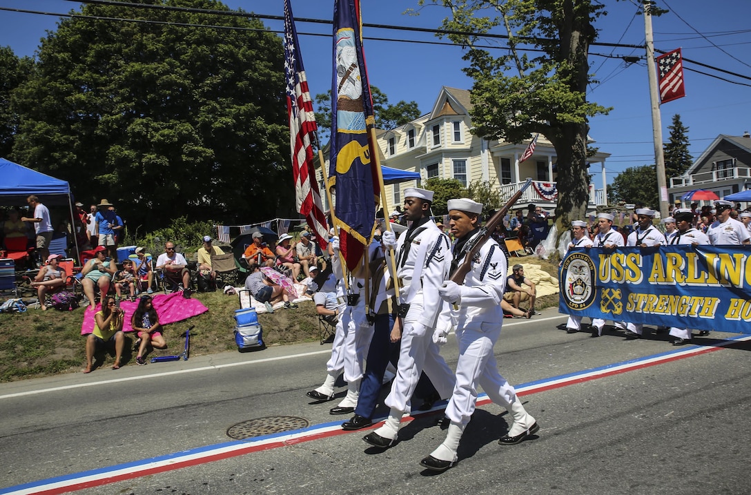 The color guard representing the USS Arlington marches during the Bristol Fourth of July Parade in Bristol, Rhode Island, July 4, 2016. Marines marched directly behind the sailors of the USS Arlington and Navy officer candidates from Naval Officer Training Command Newport, RI. (U.S. Marine Corps photo by Cpl. Paul S. Martinez/Released)