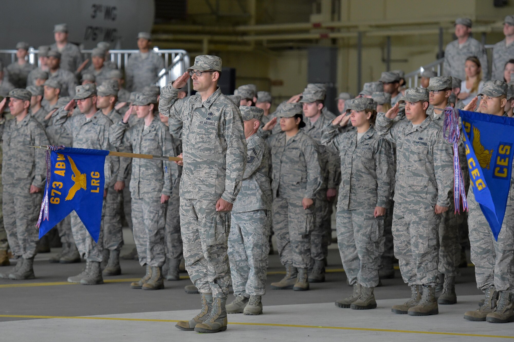 The formation salutes during the 673d Air Base Wing and Joint Base Elmendorf-Richardson, Alaska, change of command ceremony at Hangar 1 on JBER, Monday, July 11, 2016. U.S. Air Force Col. Brian Bruckbauer turned over command to Air Force Col. George Dietrich III as Air Force Lt. Gen. Russell Handy, the appointed commander of Pacific Air Forces, officiated before gathered family members, distinguished guests and military personnel. (U.S. Air Force photo/Justin Connaher)